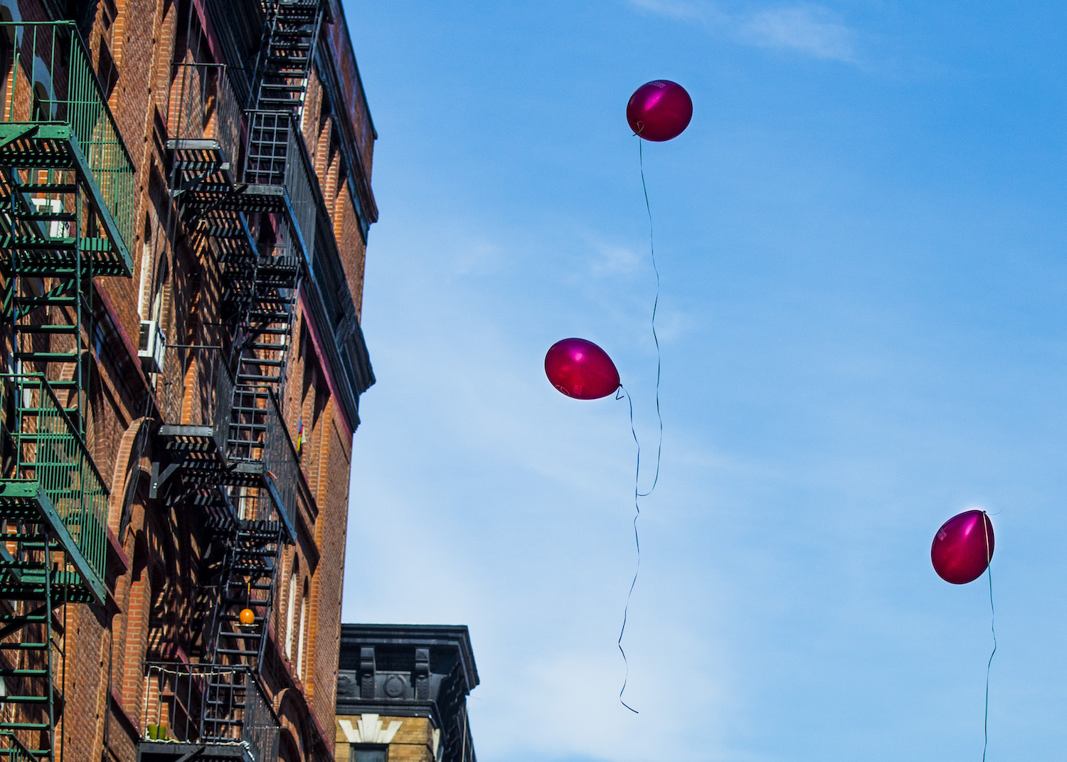 Red balloons outside an NYC apartment building